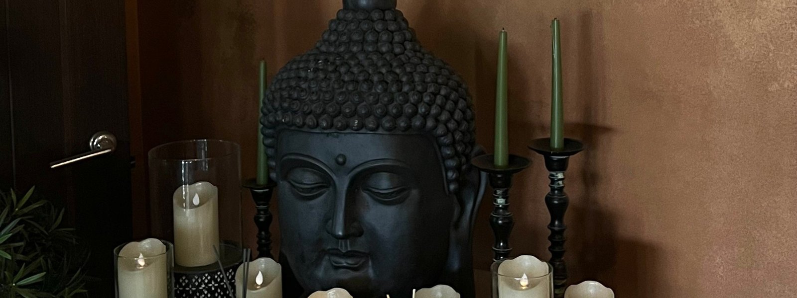 A handmade Buddha altar styled with a candle in a home